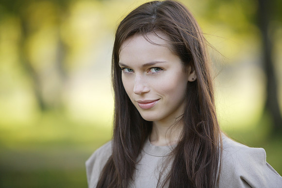 beautiful woman close-up portrait with nature background