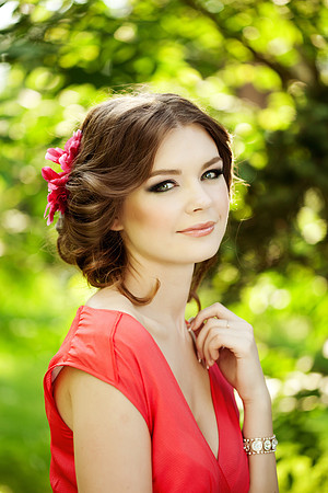 Beautiful woman with a flower in the hairstyle